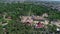 Ferris wheel in the park, aerial view. A large ferris wheel in the middle of a green park filming with a drone