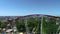 Ferris wheel in the park, aerial view. A large ferris wheel in the middle of a green park filming with a drone