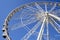 Ferris wheel perspective against blue sky