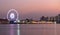 Ferris wheel river side at twilight time on Bangkok cityscape