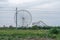 Ferris wheel and rollercoaster seen from the countryside in southern China, Guangxi province