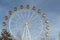 Ferris wheel with the round closed cabins against thesky