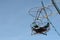 Ferris wheel with round open cabins against of the blue sky