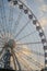 Ferris wheel at sunset with sculpture in Budapest, Hungary. 60 meters high giant ferris wheel stands in the city square.