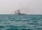 Ferry boat of Bay of Bengal smoke coming from its chimney. Black exhaust fumes coming from the chimney of a moored tanker.