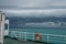 Ferry Boat with Orange Life-Buoy Ring Sail in Bad Weather with Thunderclouds. Marine Safety Concept