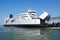 Ferry boat at pier loading cargo from port