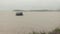 Ferry boat reaching riverbank on a rainy day