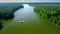 Ferry boat on the river transporting a car, aerial view