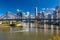 Ferry boat under Story Bridge with skyline of Brisbane, Australia