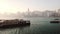 Ferry Boats Swifty Cruising Across The Calm Sea Water Near Wan Chai Pier In Hong Kong With Scenic C