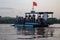 Ferry crossing Mekong river where there is no road. Boat full of passengers and motorcycles. Common mean of transportation. Viet