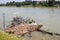 Ferry dock is impassible and unusable with river debris after heavy rain and overflow