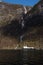 Ferry passing a waterfall, Naeroyfjorden, Norway