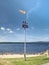 Ferry pier with windsock at the shore of Lipno lake, gentle wind