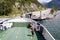 A ferry sails off from a fjord shore in Norway