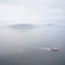 Ferry ship crossing on open vast ocean cruise journey aerial view from above during atmospheric weather sea island trip Scotland U