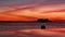 Ferry ship vessel silhouette in sea against dramatic sunset background