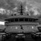 Ferry vessel passenger deck and superstructure with cloudy sky on background