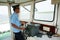 Ferryman control steering wheel in cabin\'s ferry. THAP, VIET NAM- JANUARY 27