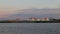 Fertilizer terminal. Large warehouses on the river at sunset