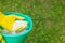 Fertilizing plants, lawns, trees and flowers. Gardener in gloves holds white fertilizer balls on grass