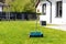 Fertilizing a young lawn with grass fertilizer in granules using a manual grass seeder.