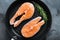 Fesh raw salmon fillet on grill skillet, over grey background, top view