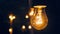 Festival decorative string lights hang and glow outdoors at night. Warm lighting, vintage garland of lamps or glass