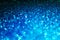 Festive abstract blue glitter texture background with shiny sparkle. Colorful defocused background with glittering and sparkling
