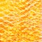 Festive abstract textured background. White curlicues on a yellow and orange background. Swirl pattern. Christmas lights