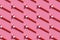 Festive air whistles on pink background. Pattern from elements of Christmas party with hard shadow. Christmas and New