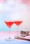 Festive alcoholic cocktail with red martini, lemonade, champagne in glasses on a bright background, bar concept, alcoholic drinks