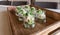 Festive appetizer glasses with avocado mousse and North Sea crab on a wooden tray.