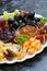 Festive appetizers - cheeses, fruits and jams, vertical closeup