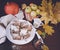 Festive apple pie with powdered sugar close-up with autumn leaves and pumpkin on the table