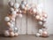 Festive arch made of pearl-colored balloons in pastel colors