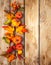 Festive autumn decor from pumpkins, berries and leaves on a rustic wooden background. Concept of Thanksgiving day or Halloween.