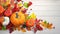 Festive autumn decor from pumpkins, berries and leaves on a white wooden background. Concept of Thanksgiving day or Halloween.