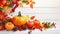 Festive autumn decor from pumpkins, berries and leaves on a white wooden background. Concept of Thanksgiving day or Halloween.