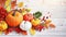 Festive autumn decor from pumpkins, berries and leaves on a white wooden background. Concept of Thanksgiving day or Halloween.