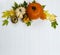 Festive autumn decor from pumpkins, real maple leaves on a white wooden background