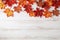 Festive autumn leaves decor on white wooden table with copy space , Textured vintage background. Generative AI