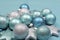 Festive background of aqua pale blue christmas glitter baubles - selective focus