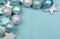 Festive background of aqua pale blue christmas glitter baubles w\' copy space
