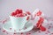 Festive background. Coffee cup, full of multicolor sweet sprinkles sugar candy hearts and packing Valentine`s Day gifts