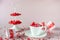 Festive background. Coffee cup, white two tier serving tray full of multicolor sweet sprinkles sugar candy hearts