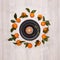 Festive background from mandarins with leaves and black plates and bowl