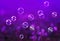 Festive background with many shiny iridescent soap bubbles fly l