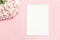 Festive background in pastel colors branch of delicate artificial hydrangea on a pink background with a notebook for writing the